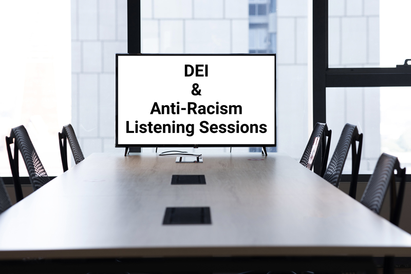 conference table with  DEI  &  Anti-Racism  Listening Sessions on the monitor 